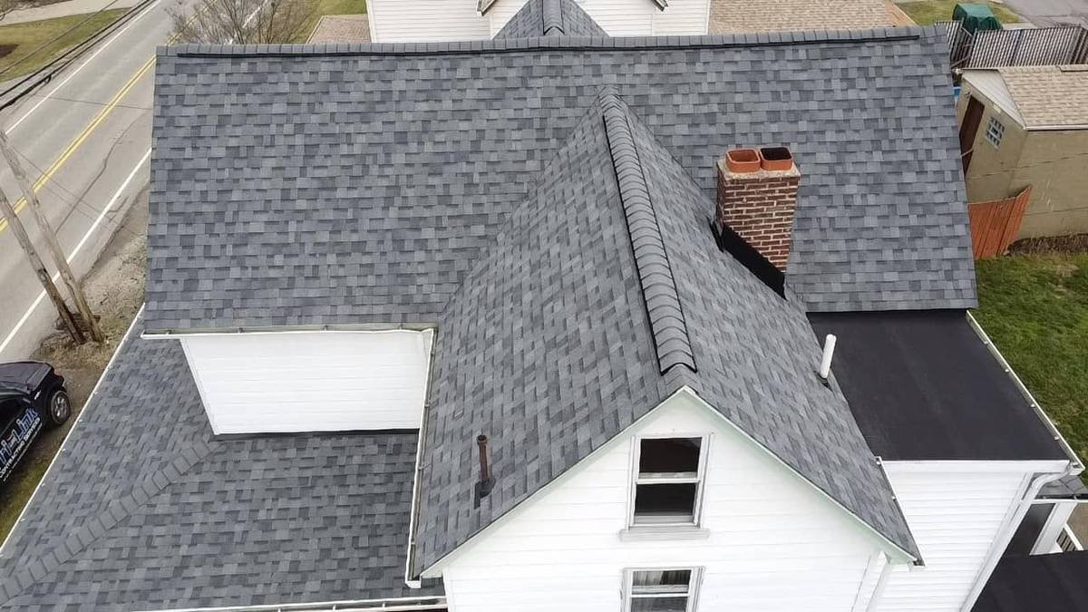 Aerial view of a gray shingle roof on a white home